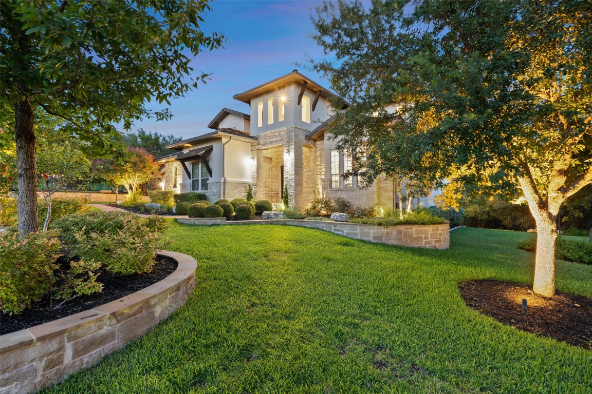 13009 Zen Gardens Way Austin, TX 78732 - Photo 5 of 40 a front view of a house with a yard and fountain