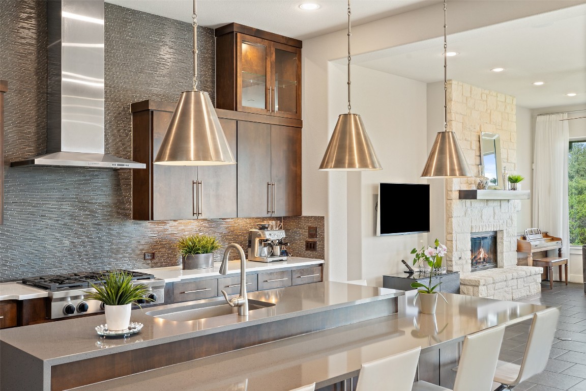 13009 Zen Gardens Way Austin, TX 78732 - Photo 7 of 40 a kitchen with a refrigerator microwave and sink