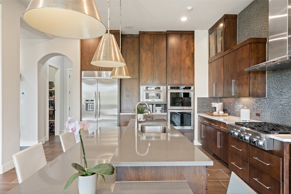 13009 Zen Gardens Way Austin, TX 78732 - Photo 9 of 40 a kitchen with stainless steel appliances granite countertop a sink a stove and a refrigerator