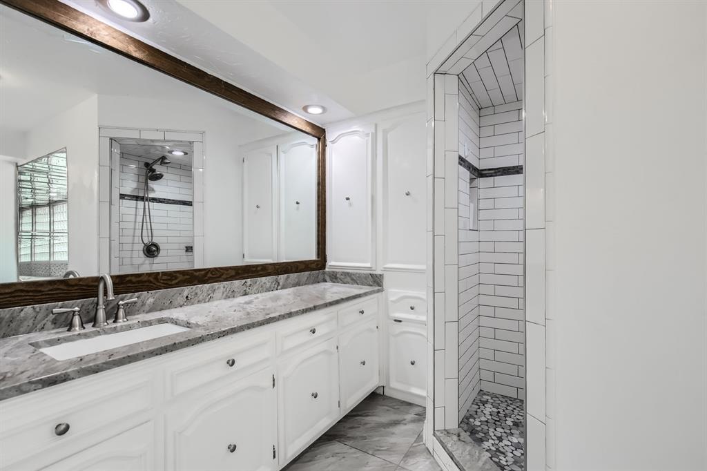 8 Canyon Ridge Drive Fate, TX 75087 - Photo 27 of 40 a bathroom with a granite countertop sink and a mirror