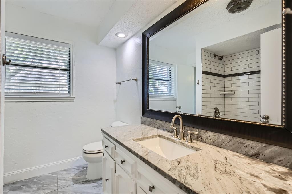 8 Canyon Ridge Drive Fate, TX 75087 - Photo 32 of 40 a bathroom with a granite countertop sink and a toilet