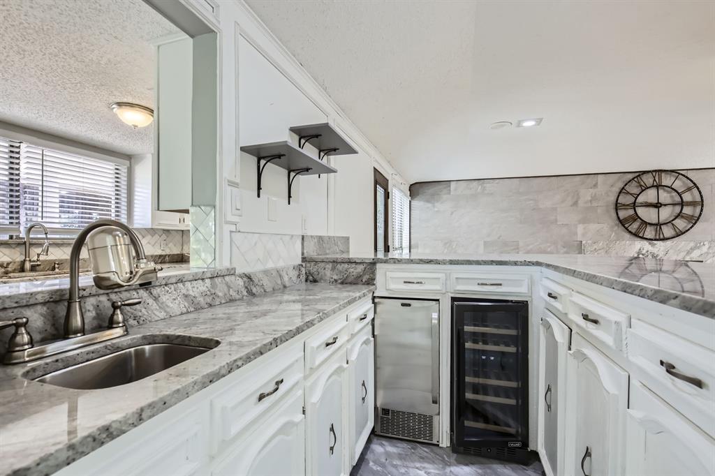 8 Canyon Ridge Drive Fate, TX 75087 - Photo 36 of 40 a kitchen with a sink and cabinets