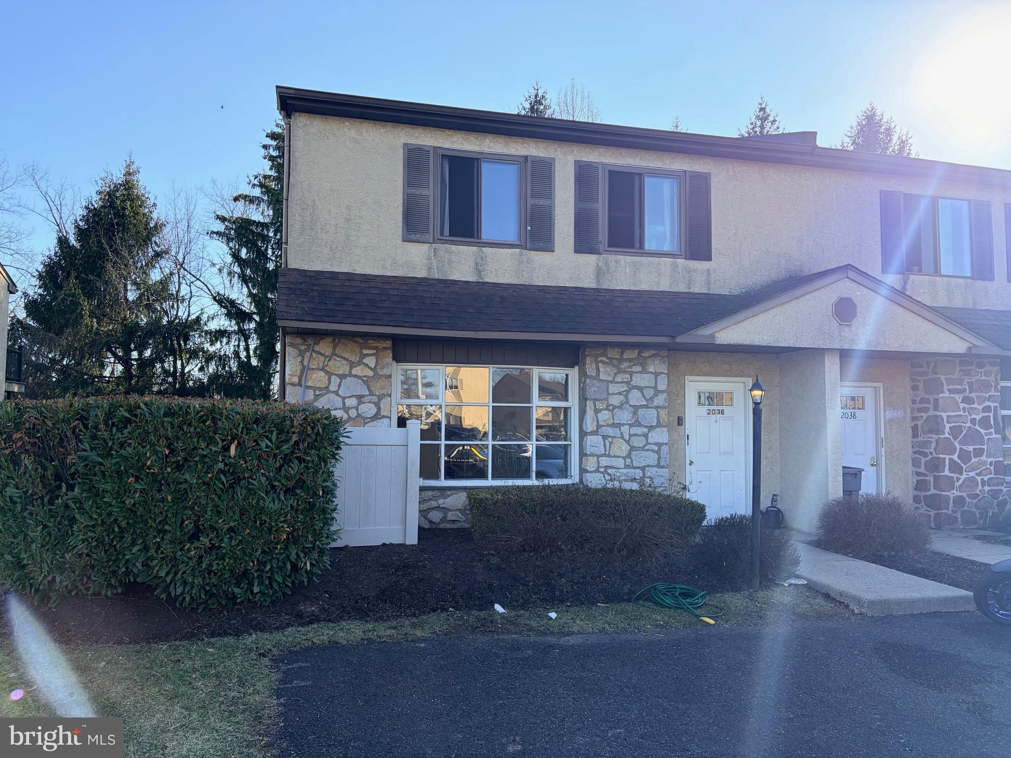 2036 Jason Drive, Unit A Huntingdon Valley, PA 19006 - Photo 1 of 10 a front view of a house with a yard and garage