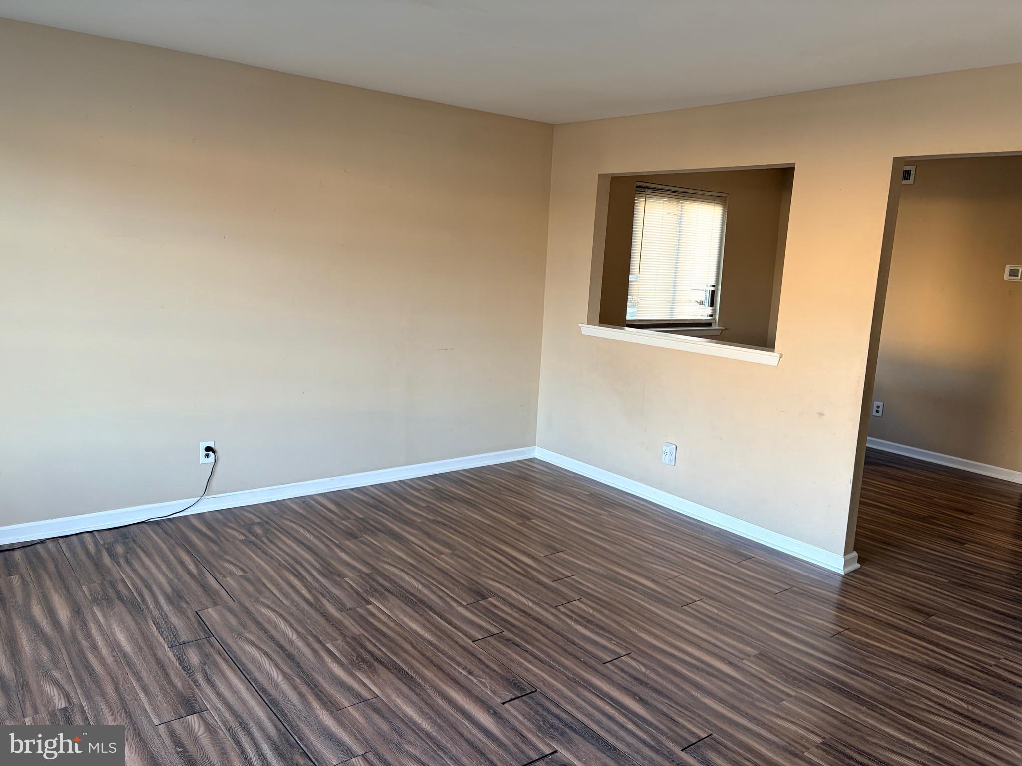 2036 Jason Drive, Unit A Huntingdon Valley, PA 19006 - Photo 2 of 10 a view of an empty room with wooden floor and a window