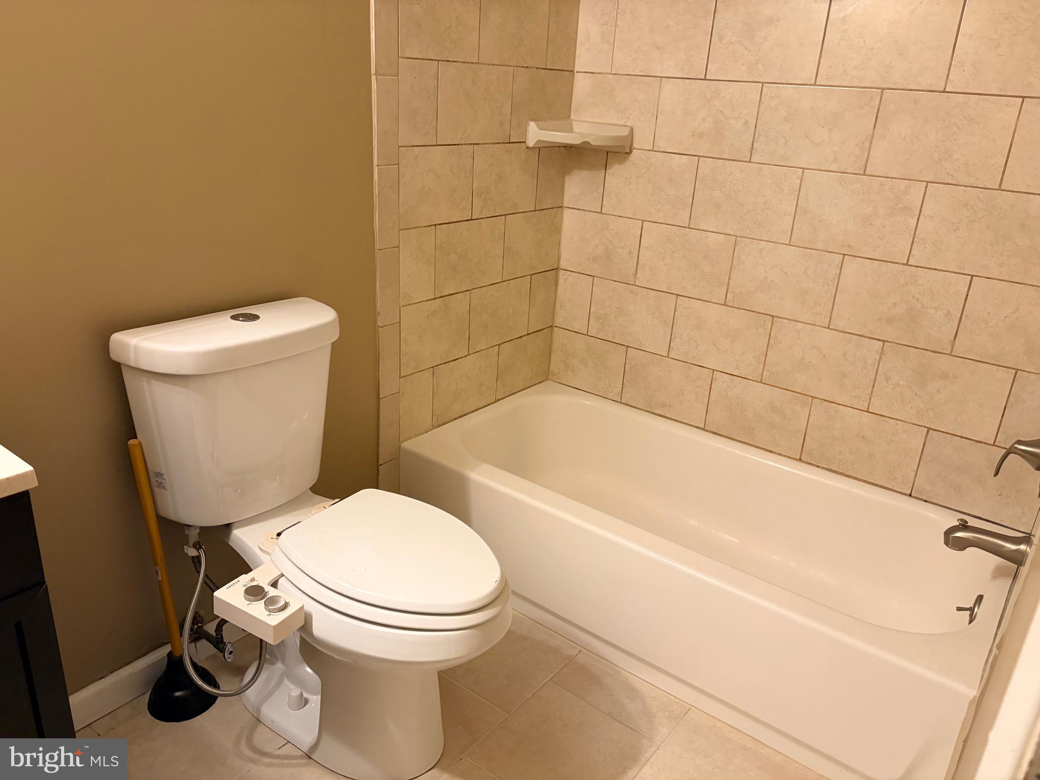 2036 Jason Drive, Unit A Huntingdon Valley, PA 19006 - Photo 5 of 10 a white toilet sitting next to a bath tub