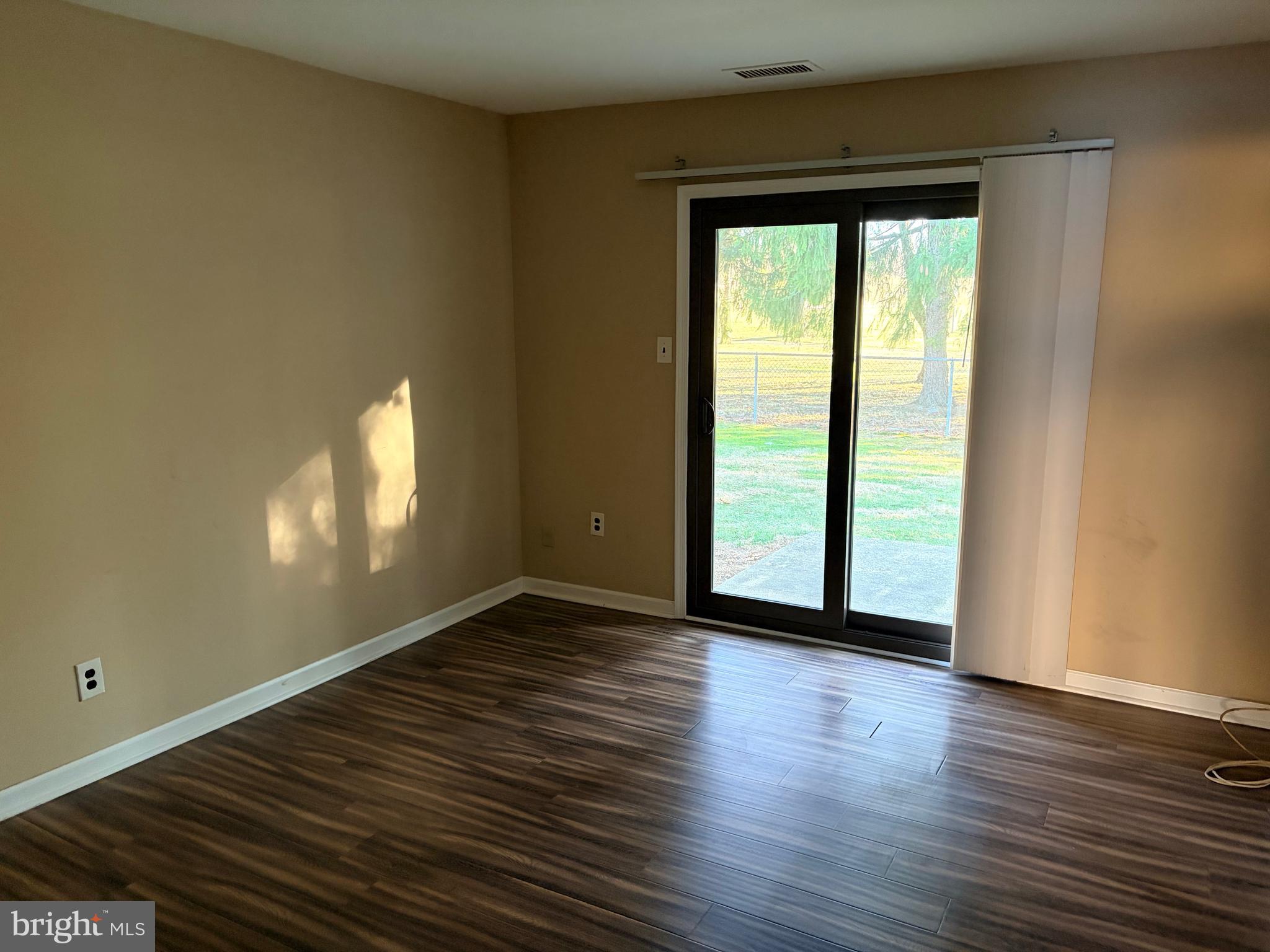 2036 Jason Drive, Unit A Huntingdon Valley, PA 19006 - Photo 6 of 10 a view of an empty room with wooden floor and a window