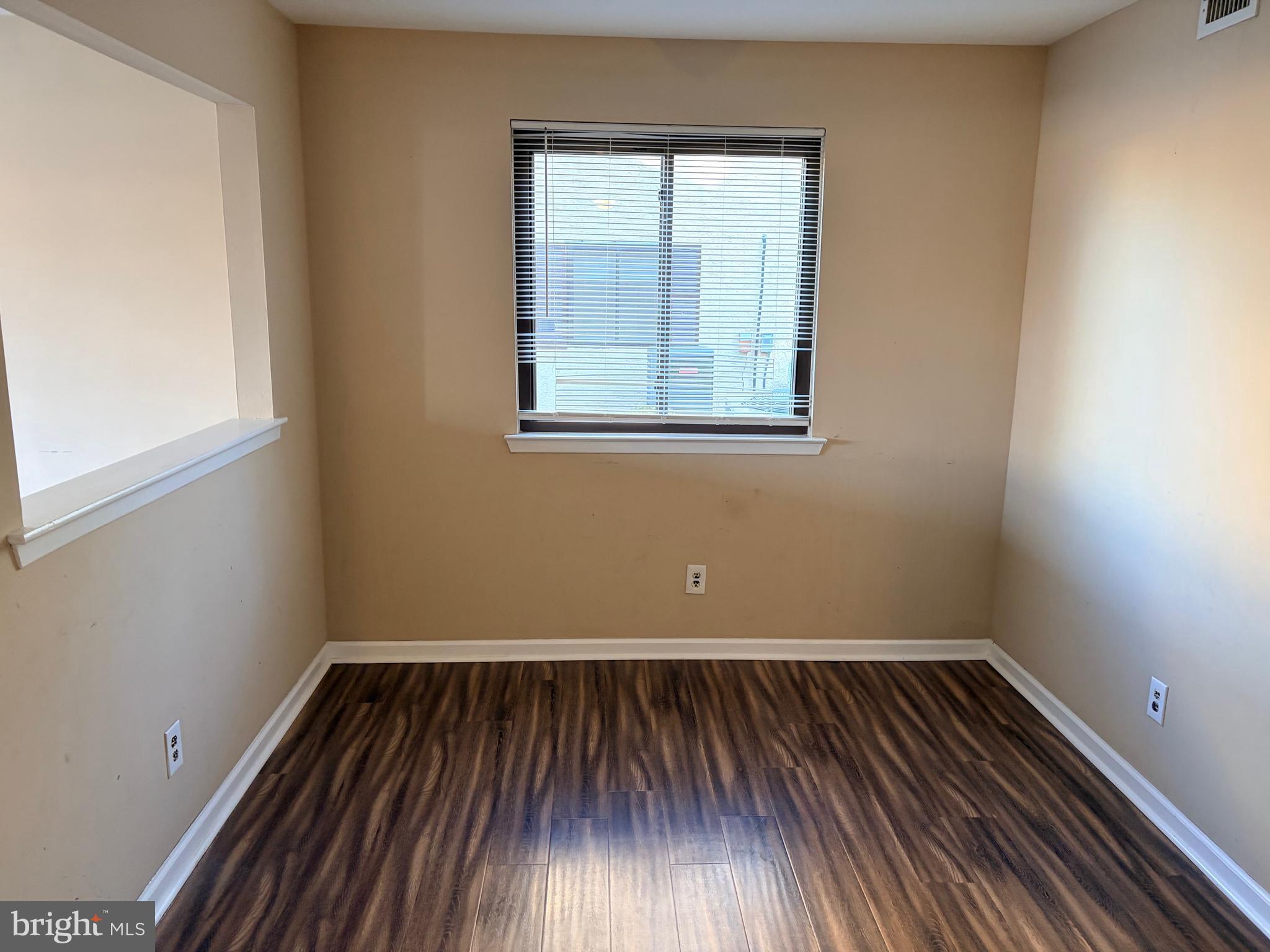 2036 Jason Drive, Unit A Huntingdon Valley, PA 19006 - Photo 7 of 10 an empty room with wooden floor and windows