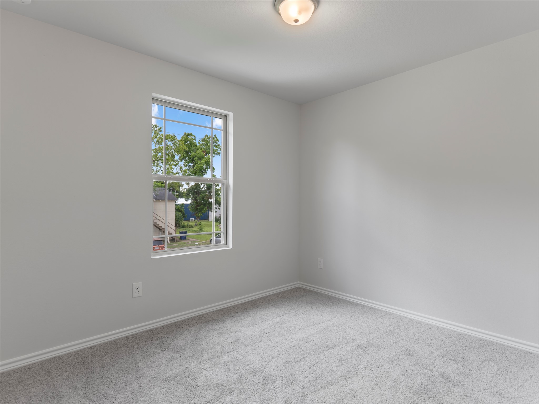 306 North Orange Street Sweeny, TX 77480 - Photo 23 of 30 Cozy upstairs bedroom with plush carpeting and abundant natural light.