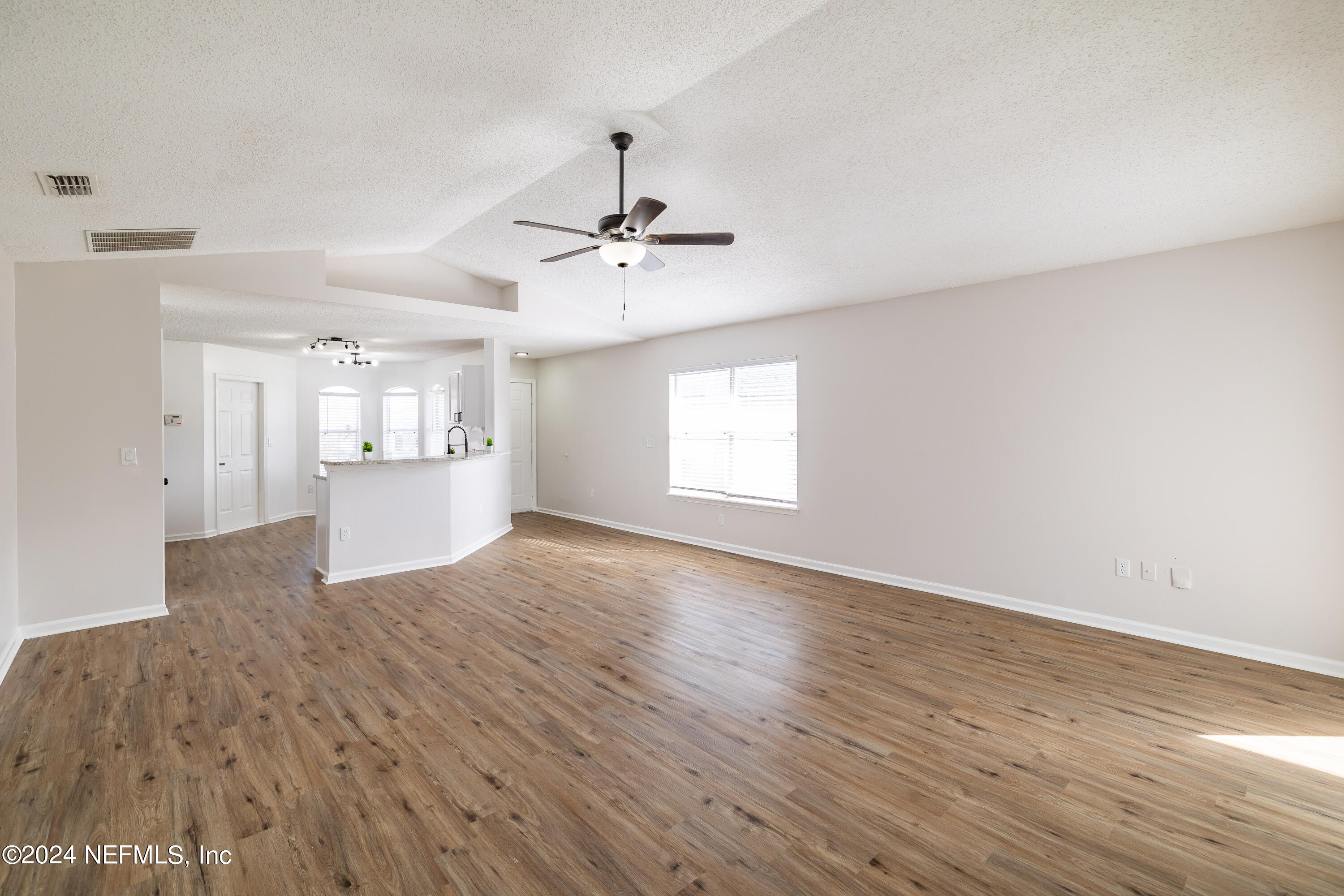 620 Morning Mist Way Orange Park, FL 32073 - Photo 12 of 34 a view of an empty room with a window and wooden floor