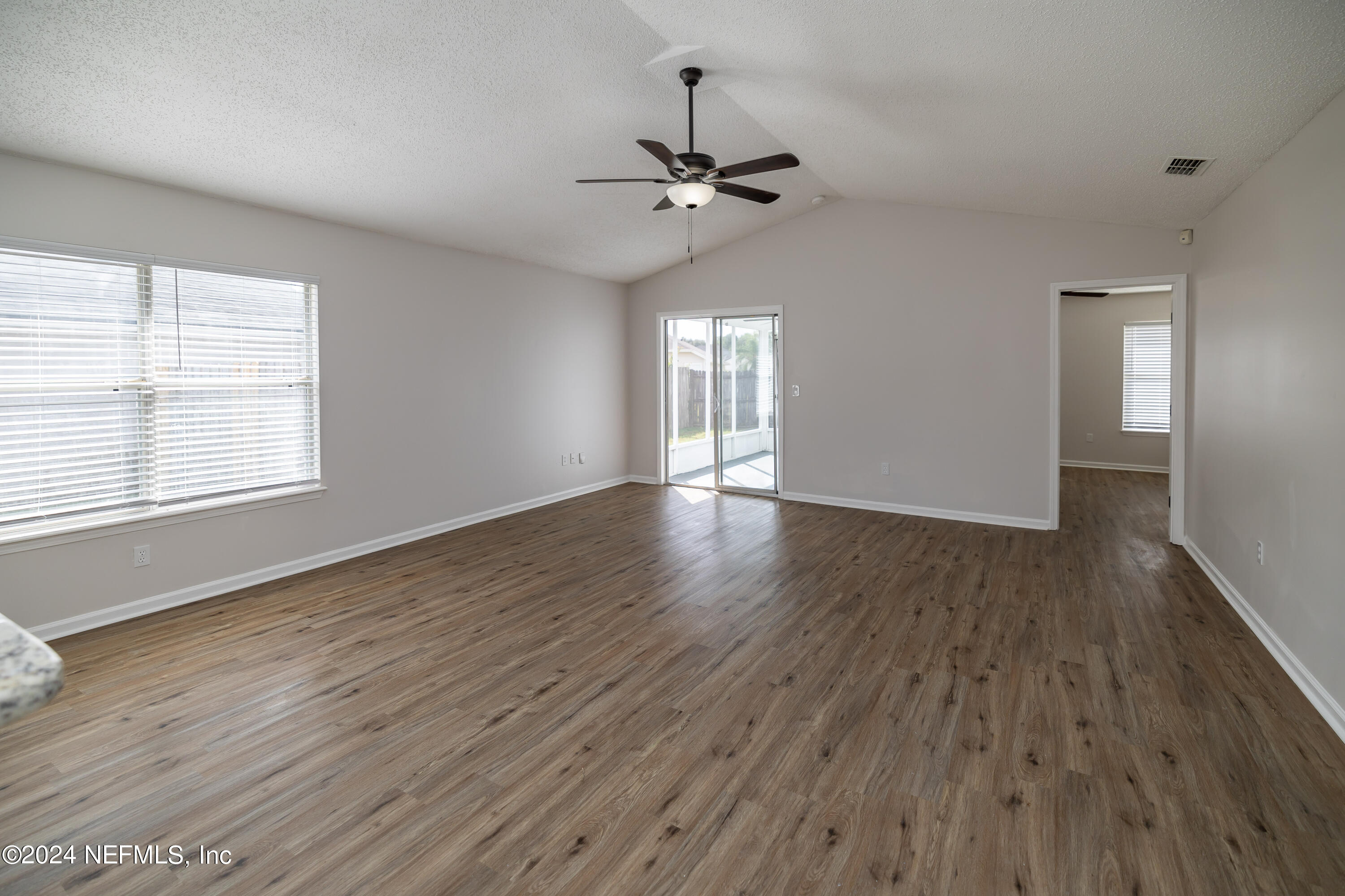620 Morning Mist Way Orange Park, FL 32073 - Photo 13 of 34 wooden floor in an empty room with a window