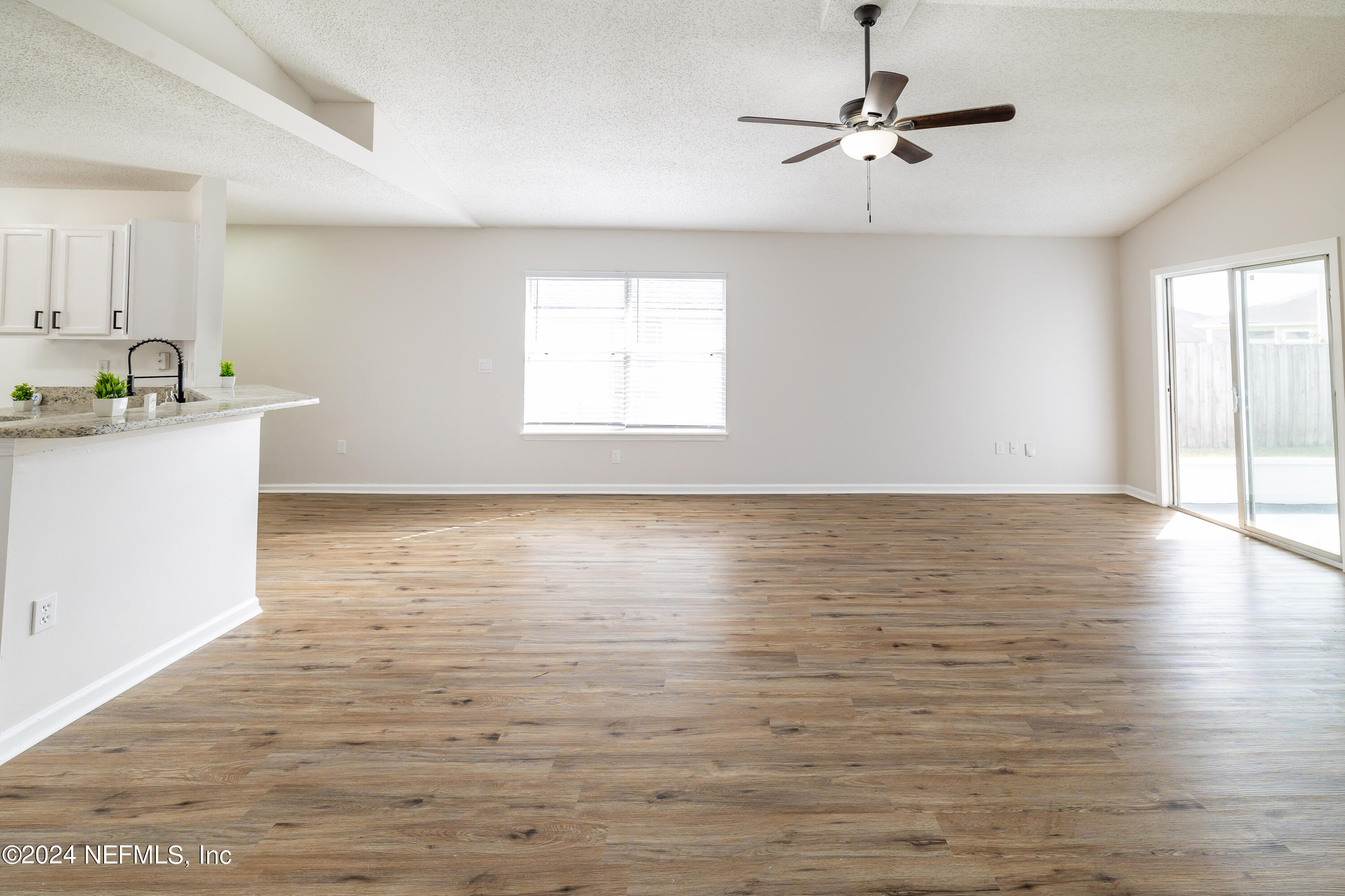 620 Morning Mist Way Orange Park, FL 32073 - Photo 14 of 34 a view of an empty room with window and wooden floor