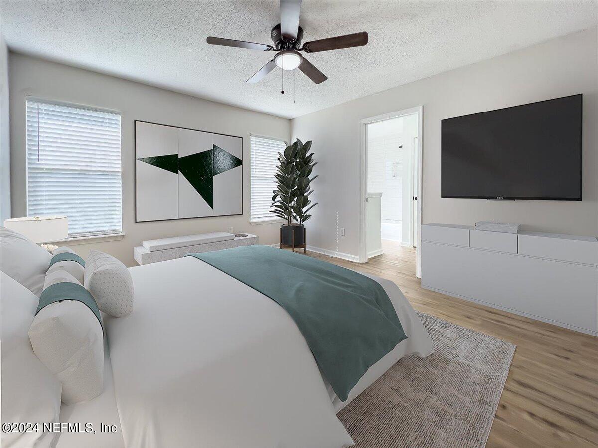 620 Morning Mist Way Orange Park, FL 32073 - Photo 15 of 34 a bedroom with a bed and a flat screen tv