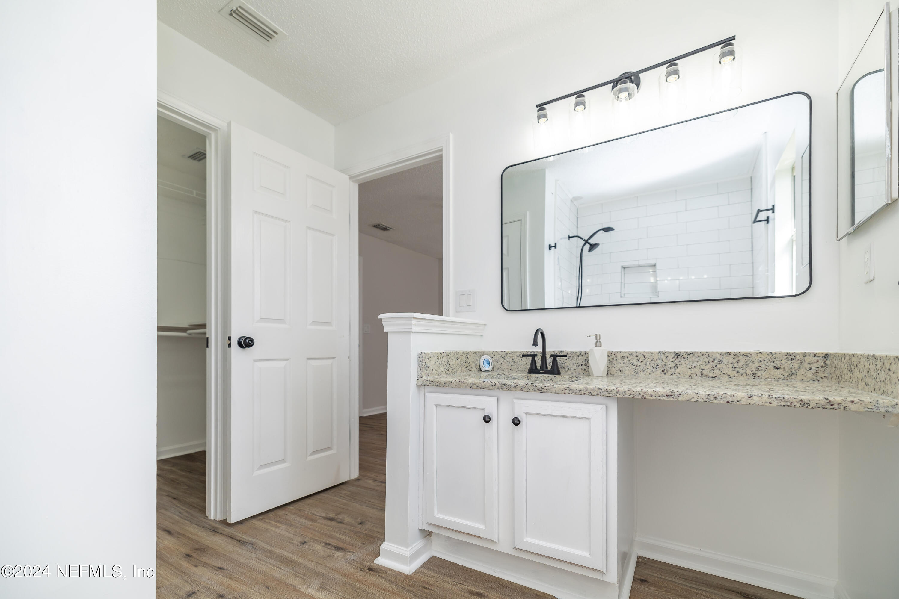 620 Morning Mist Way Orange Park, FL 32073 - Photo 16 of 34 a en suite bathroom with a granite countertop sink and a mirror