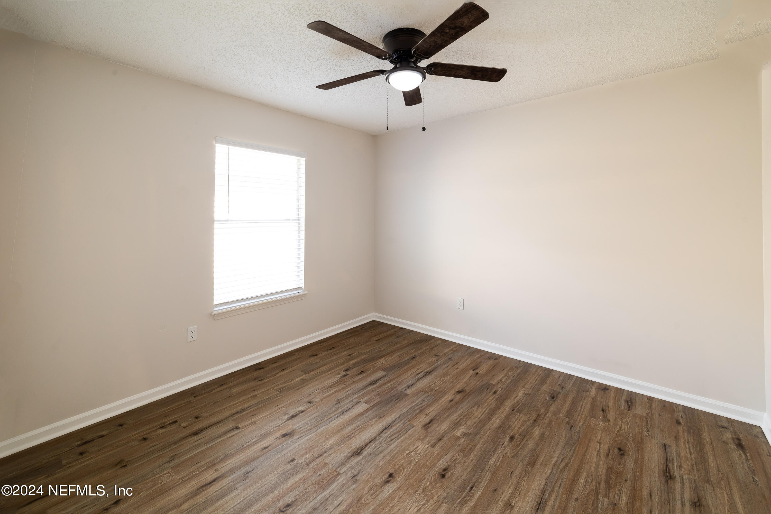 620 Morning Mist Way Orange Park, FL 32073 - Photo 19 of 34 an empty room with wooden floor and windows