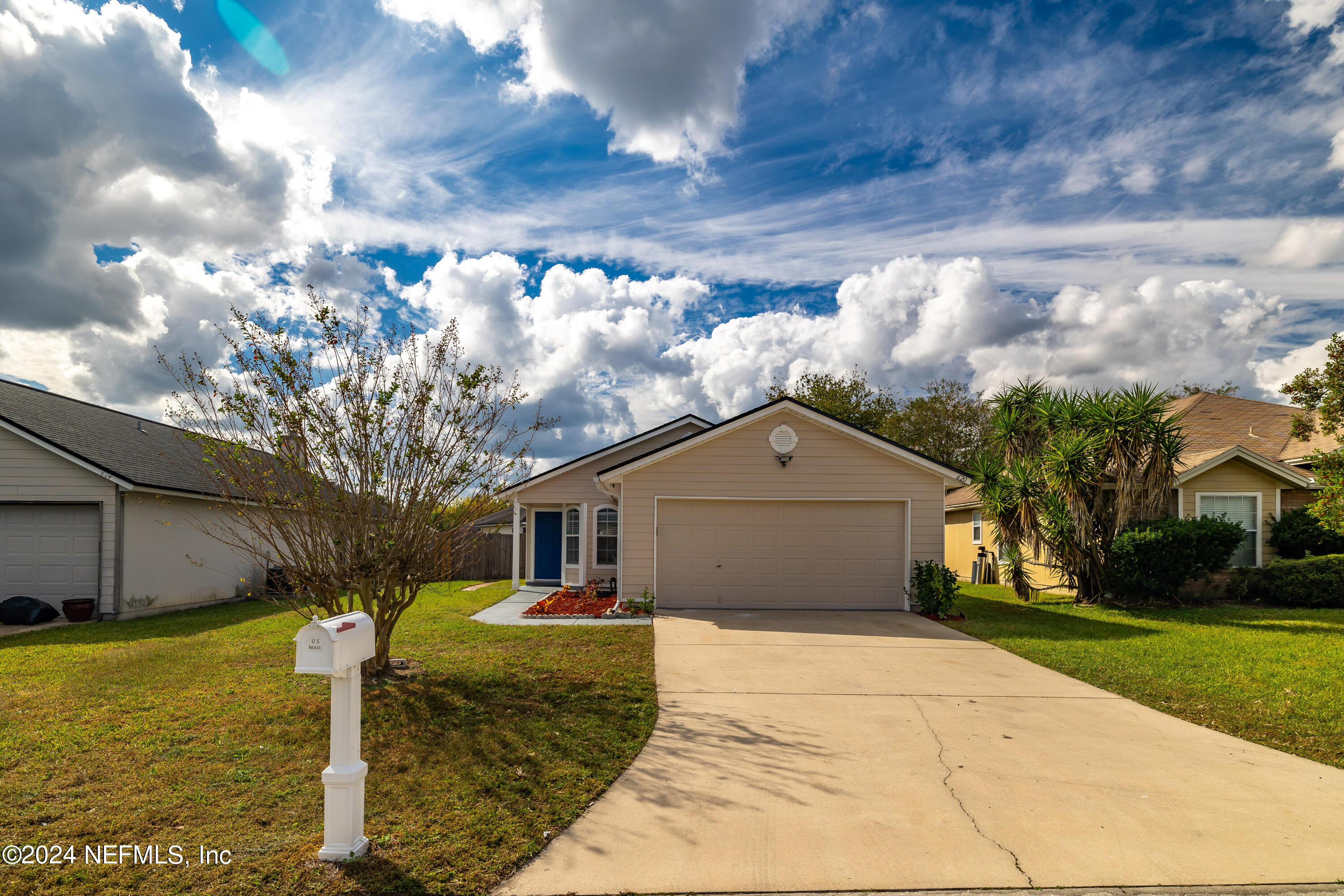 620 Morning Mist Way Orange Park, FL 32073 - Photo 2 of 34 a front view of a house with garden