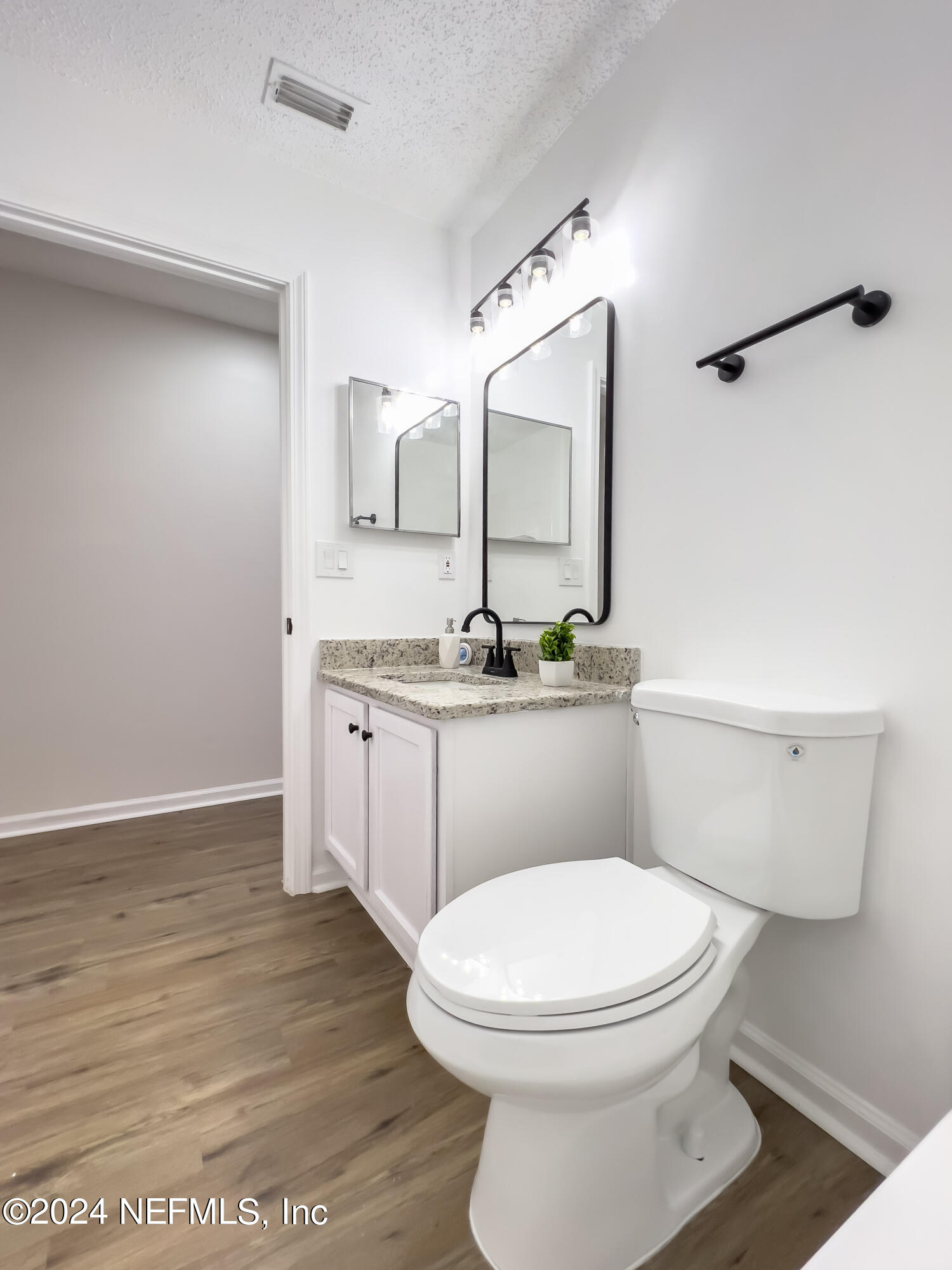 620 Morning Mist Way Orange Park, FL 32073 - Photo 21 of 34 a white toilet sitting next to a bathroom sink