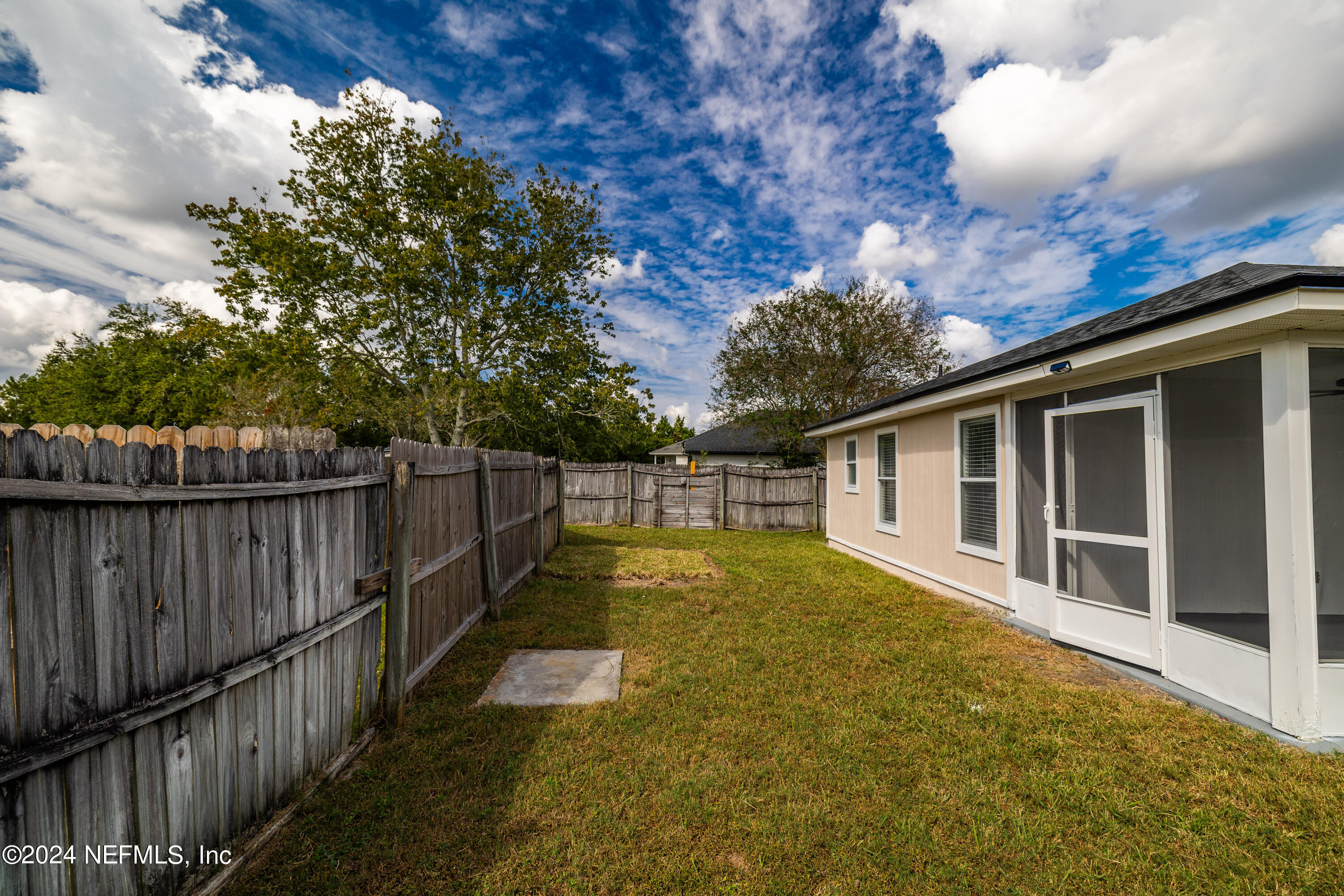 620 Morning Mist Way Orange Park, FL 32073 - Photo 23 of 34 a view of small yard with large trees and wooden fence