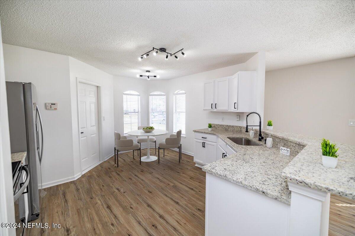 620 Morning Mist Way Orange Park, FL 32073 - Photo 5 of 34 a large kitchen with granite countertop a lot of counter space and stainless steel appliances