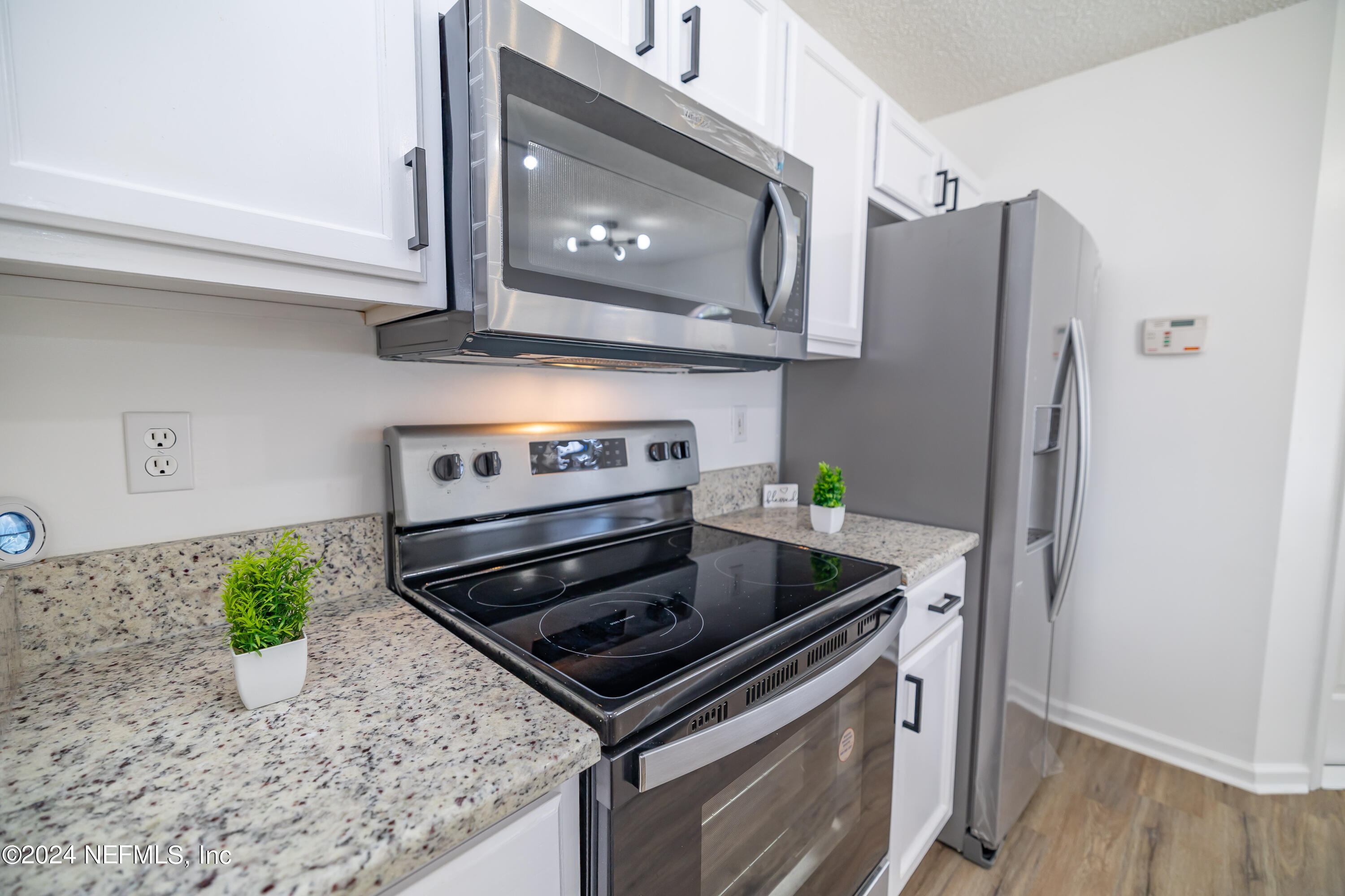 620 Morning Mist Way Orange Park, FL 32073 - Photo 6 of 34 a kitchen with stainless steel appliances granite countertop a stove a refrigerator and a microwave