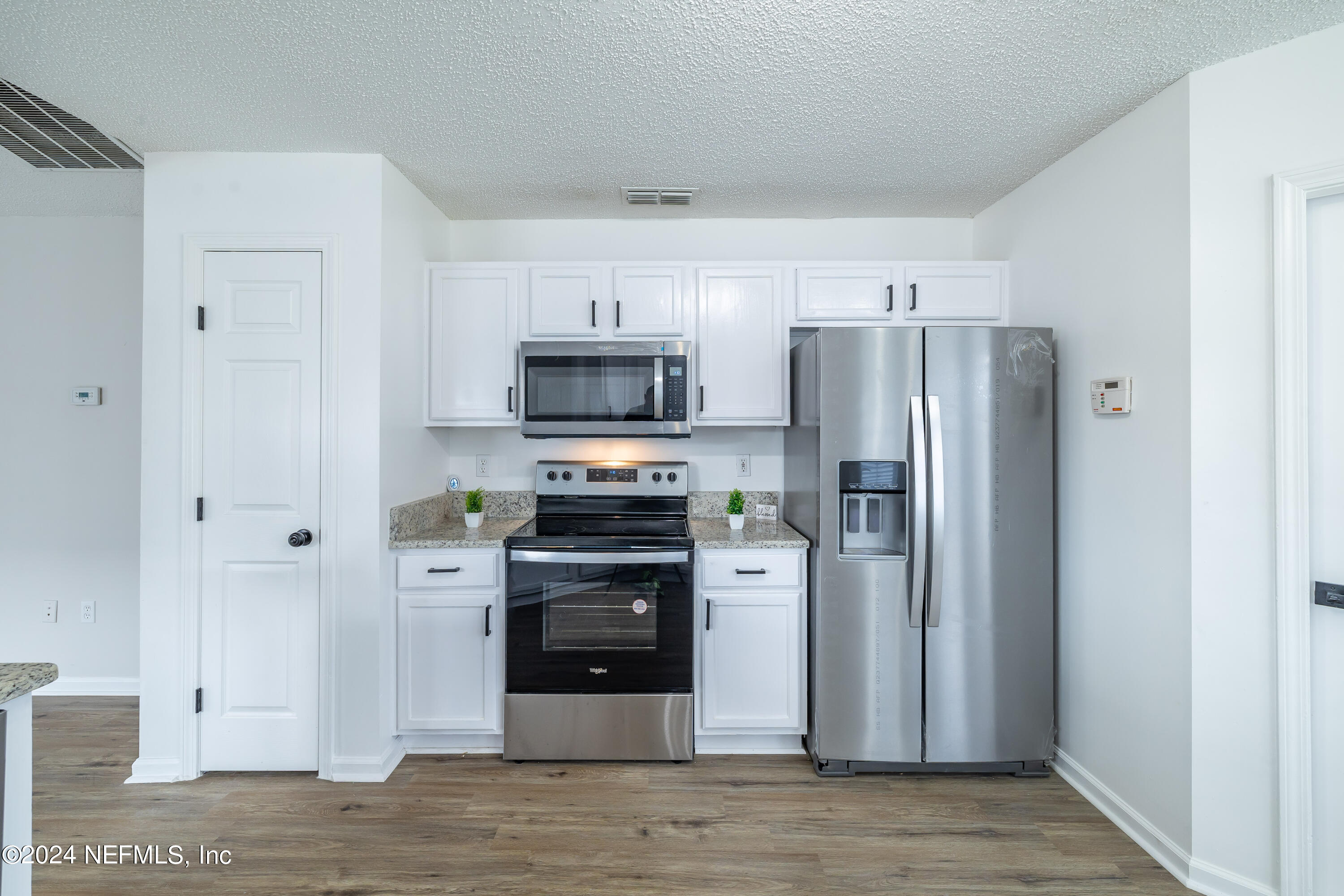 620 Morning Mist Way Orange Park, FL 32073 - Photo 7 of 34 a kitchen with stainless steel appliances a refrigerator stove and sink