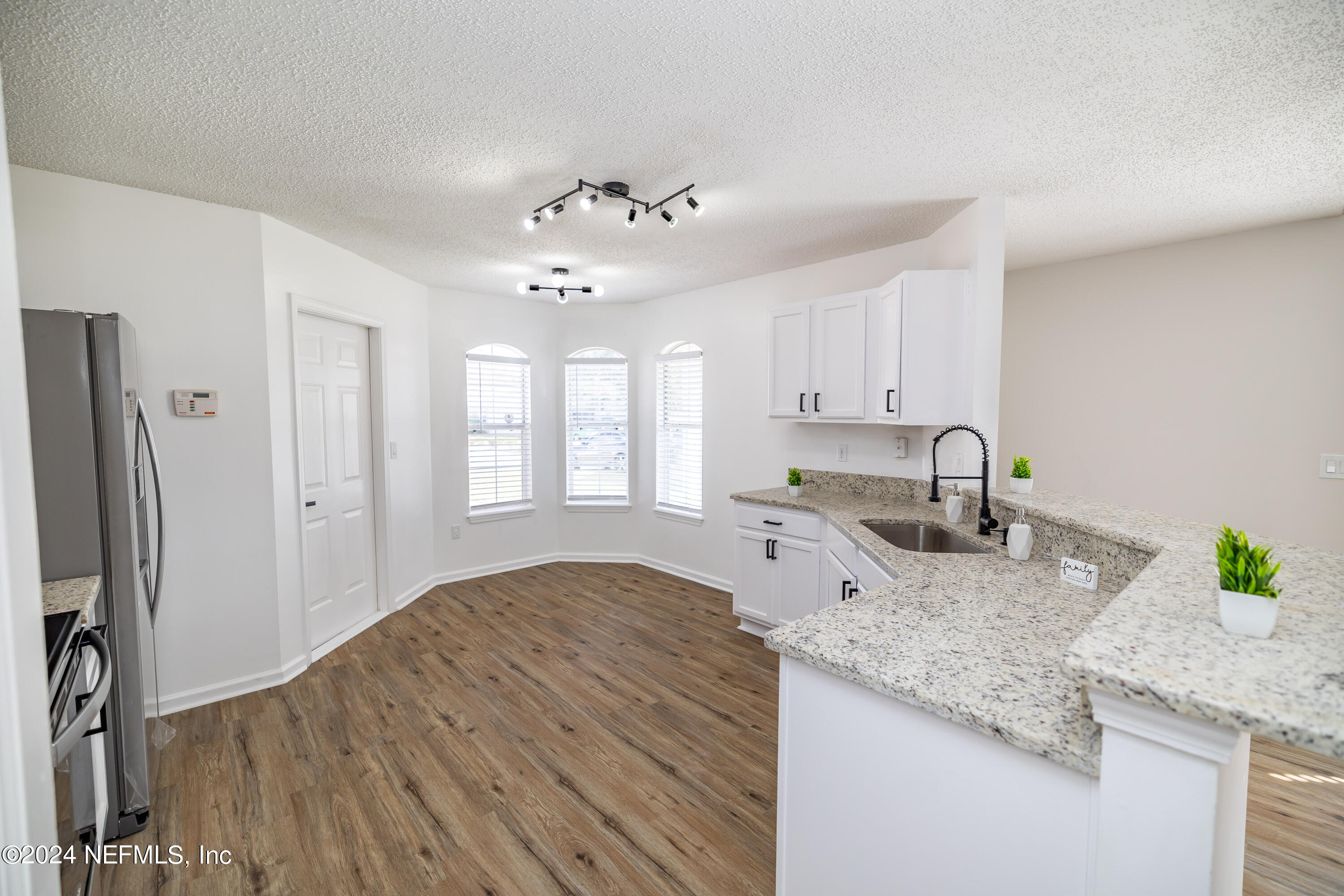 620 Morning Mist Way Orange Park, FL 32073 - Photo 9 of 34 a kitchen with granite countertop a sink cabinets stainless steel appliances and a counter space