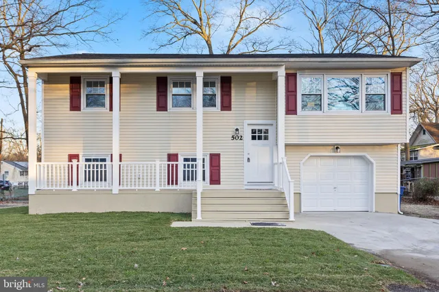 a front view of a house with a garden and yard