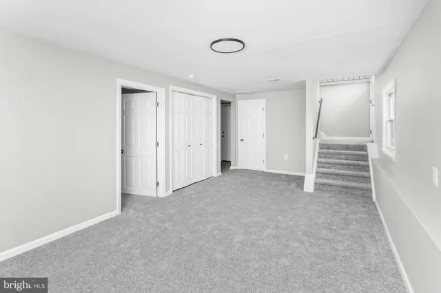 a view of an empty room with a closet