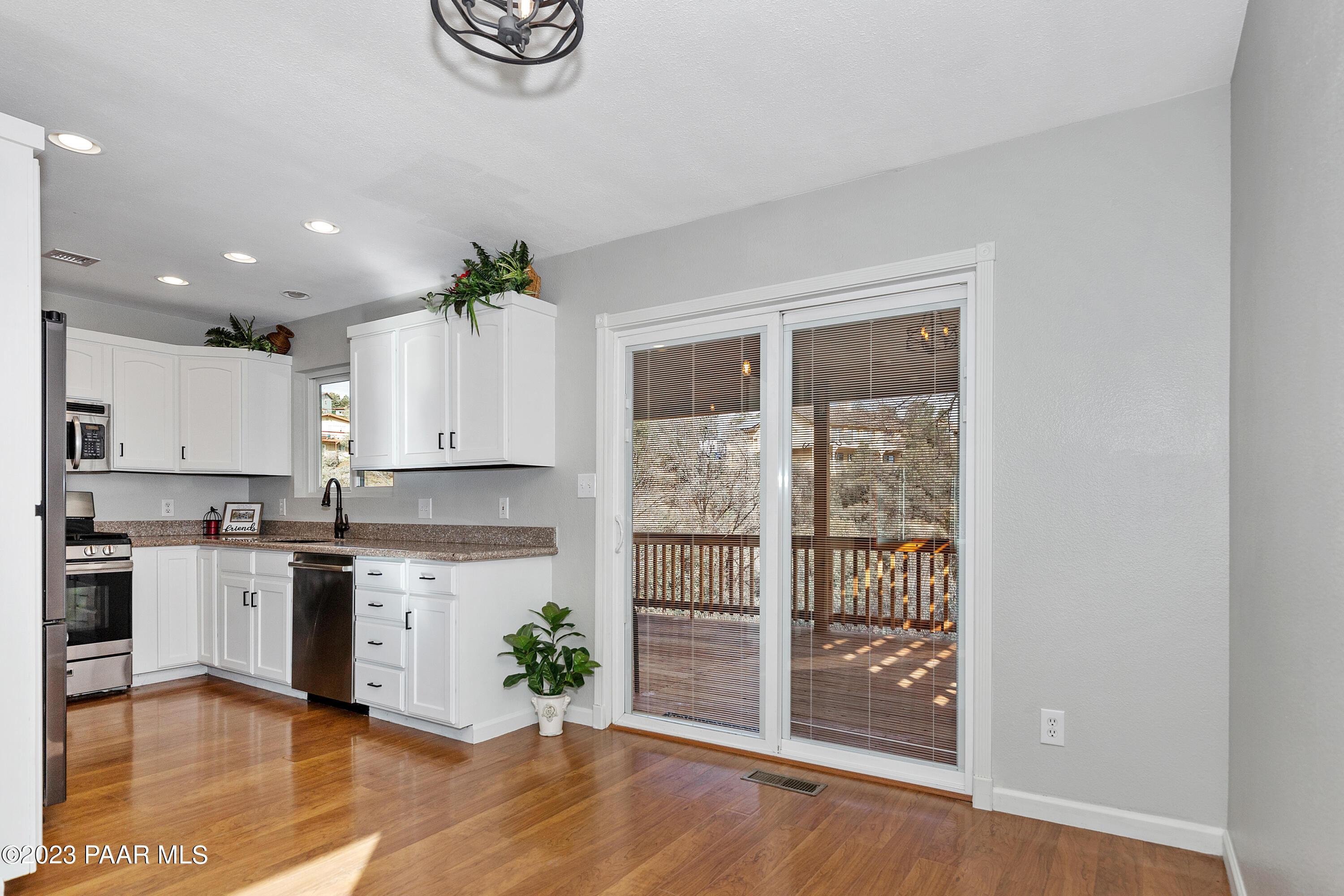 450 Valley Place Prescott, AZ 86301 - Photo 11 of 44 a kitchen with granite countertop a stove a sink and a refrigerator