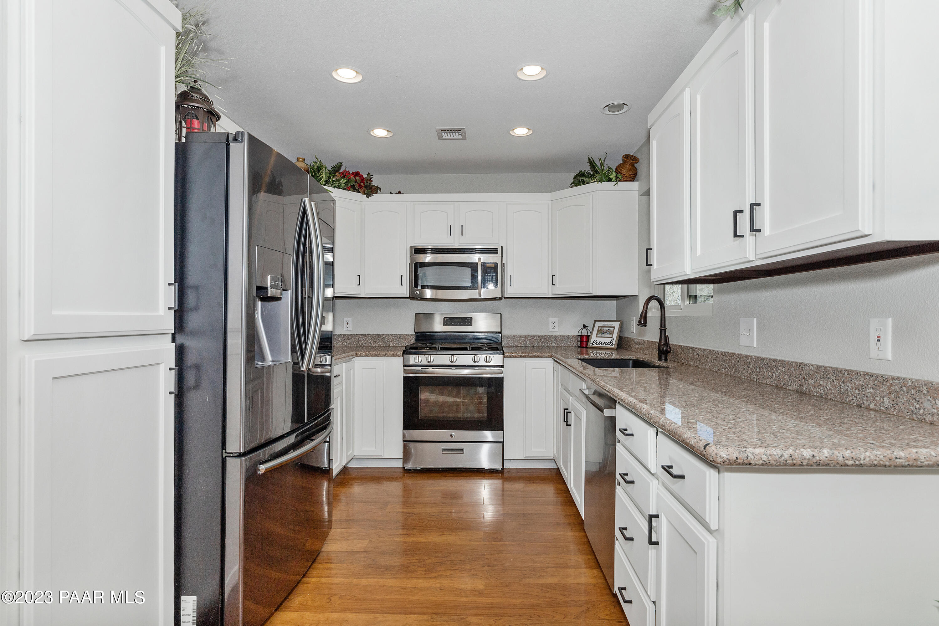 450 Valley Place Prescott, AZ 86301 - Photo 12 of 44 a kitchen with stainless steel appliances granite countertop a refrigerator sink and stove