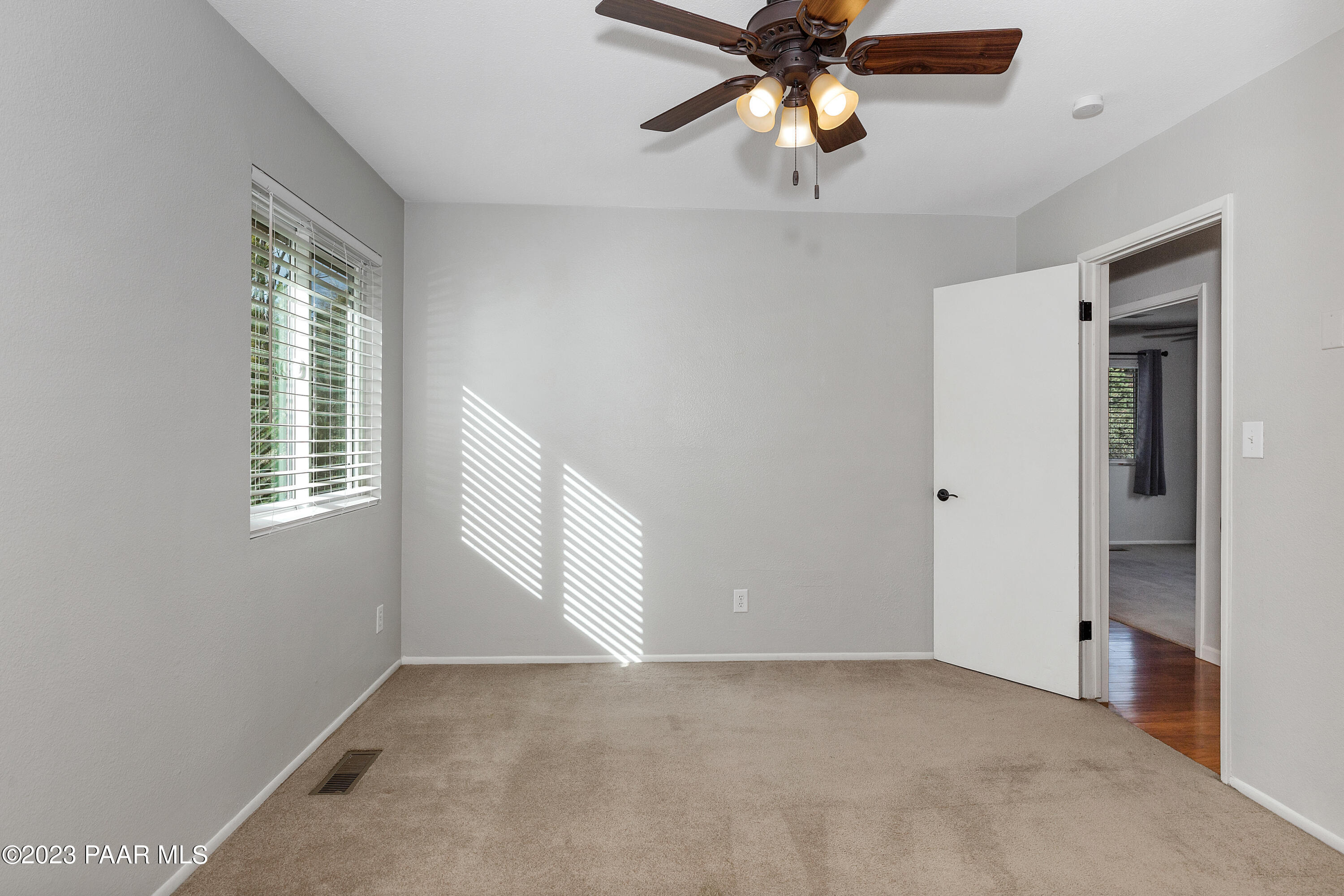 450 Valley Place Prescott, AZ 86301 - Photo 19 of 44 a view of an empty room with window and chandelier fan