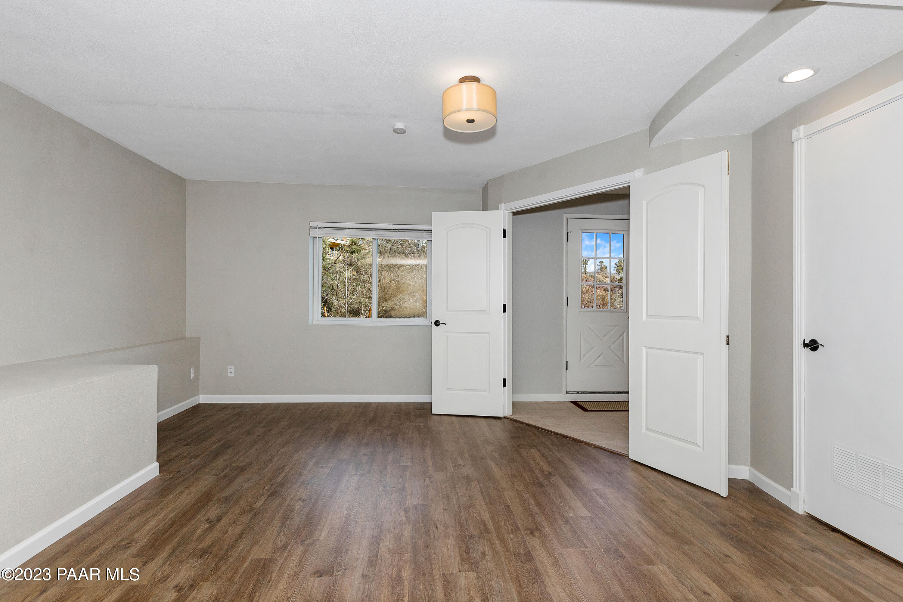 450 Valley Place Prescott, AZ 86301 - Photo 27 of 44 an empty room with wooden floor and windows