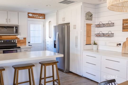 432 West Howell Avenue Ridgecrest, CA 93555 - Photo 6 of 28 a kitchen with stainless steel appliances a refrigerator and stove