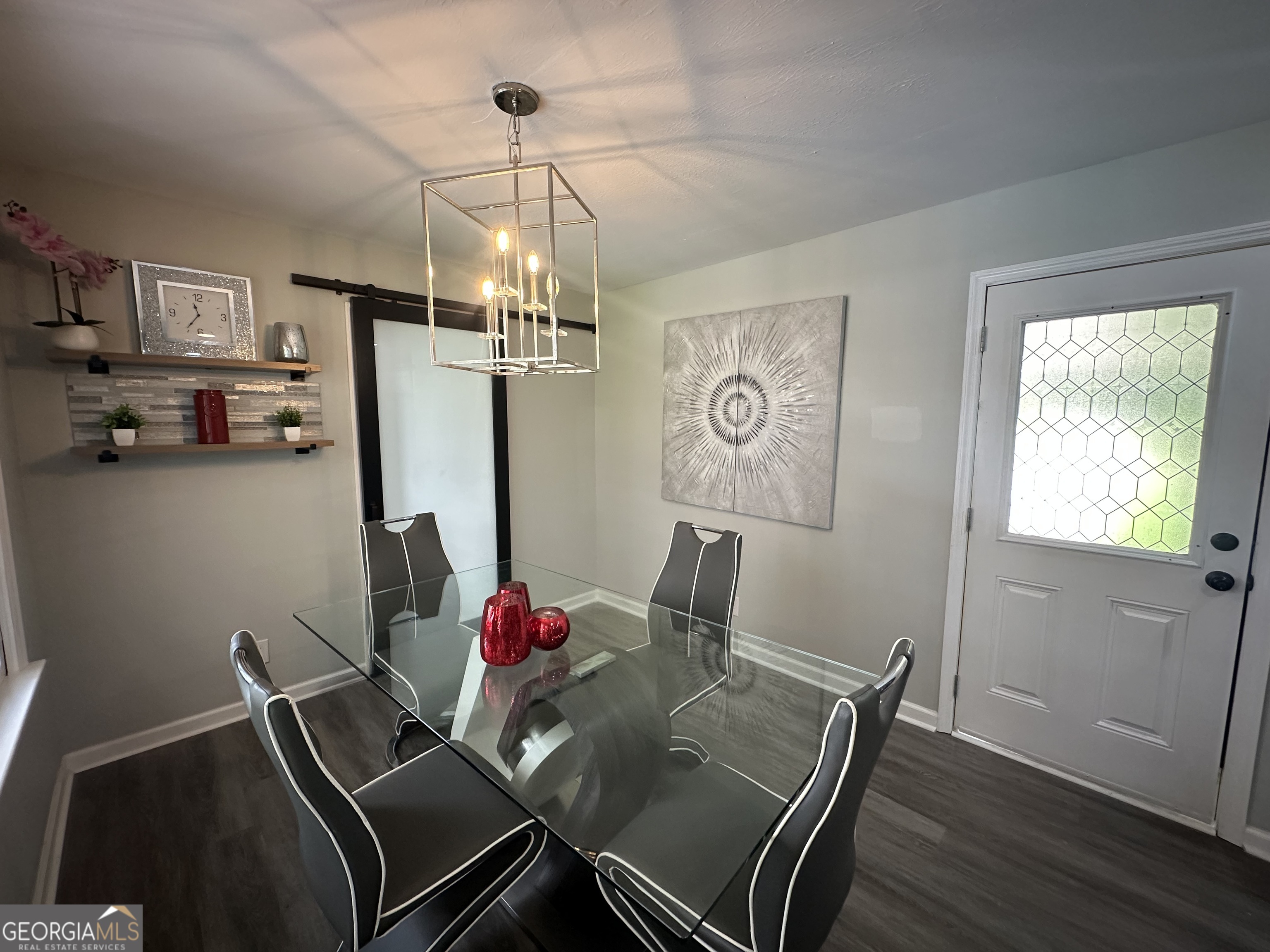 7383 Pleasant Hill Road Lithonia, GA 30058 - Photo 12 of 18 a view of a dining room with furniture a chandelier and wooden floor
