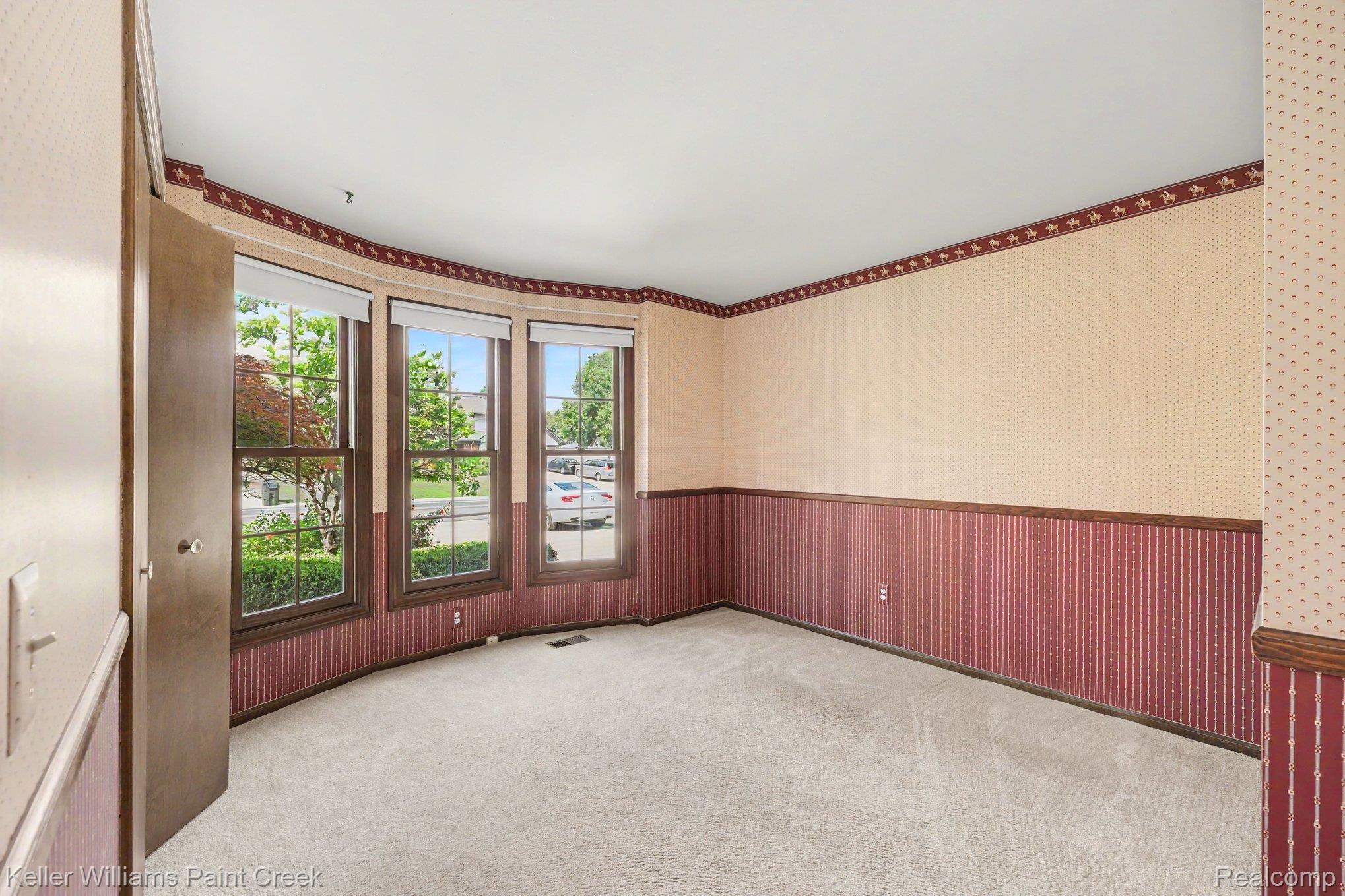 2717 Powderhorn Ridge Road Rochester, MI 48309 - Photo 26 of 48 Curved bay window, three large windows, light-colored carpeting, wood-finish trim, and built-in closet