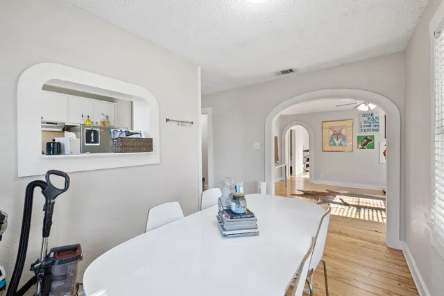 a view of a dining room with furniture and wooden floor