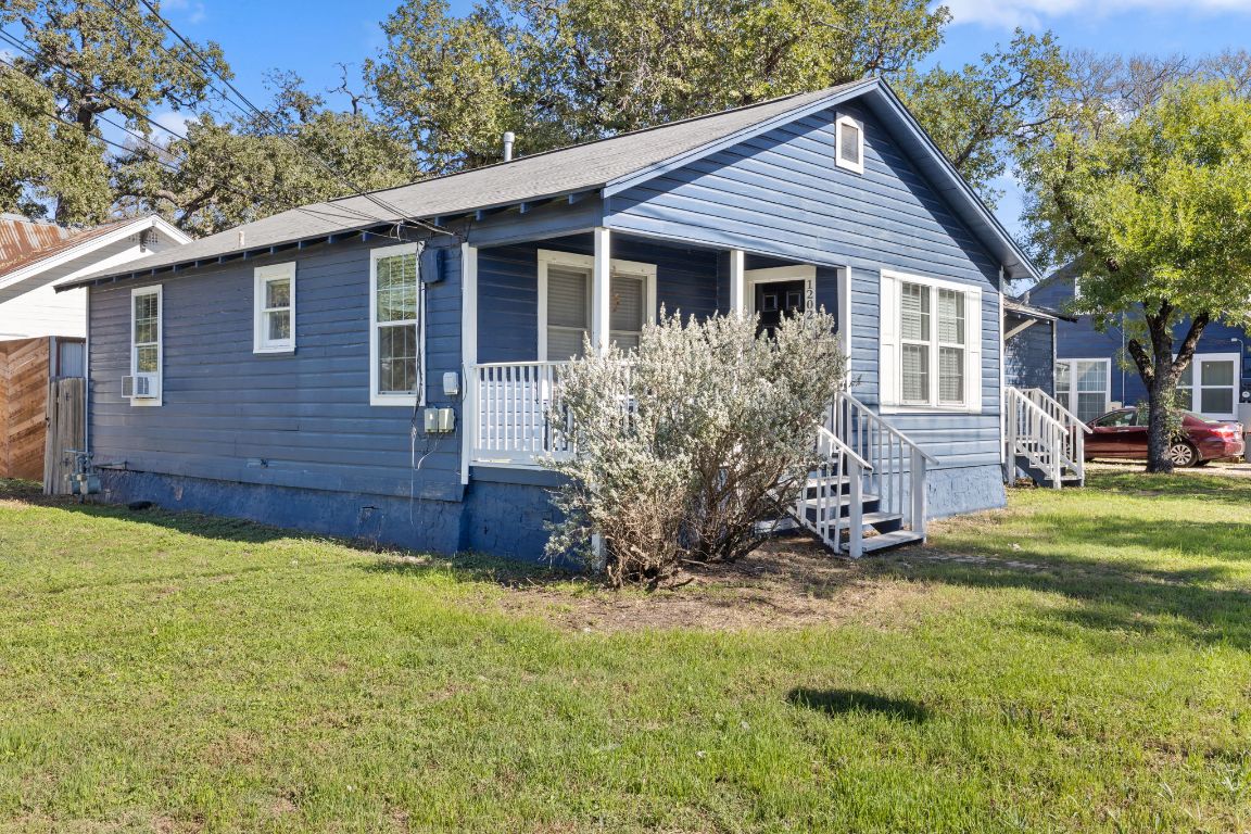 1202 East 29th Street, Unit A Austin, TX 78722 - Photo 2 of 37 Bungalow featuring covered porch, a front yard, and crawl space