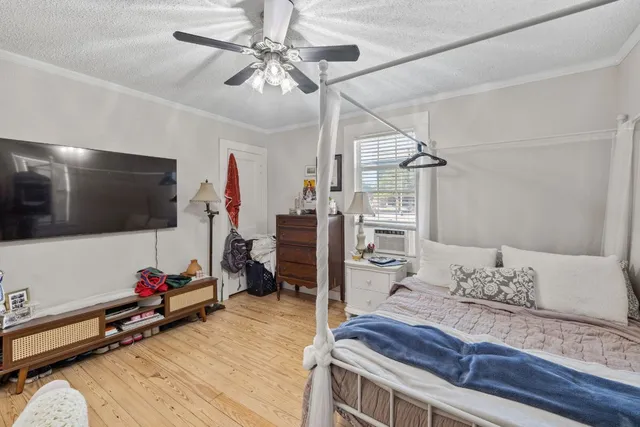 a bedroom with furniture and a window