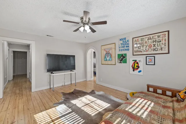 a bedroom with a bed and a television