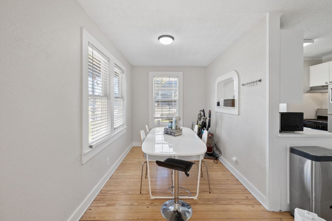 1202 East 29th Street, Unit A Austin, TX 78722 - Photo 9 of 37 Dining room featuring light wood finished floors and a textured ceiling
