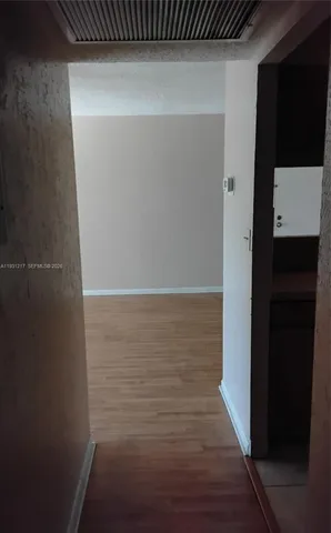 a view of closet with wooden floor