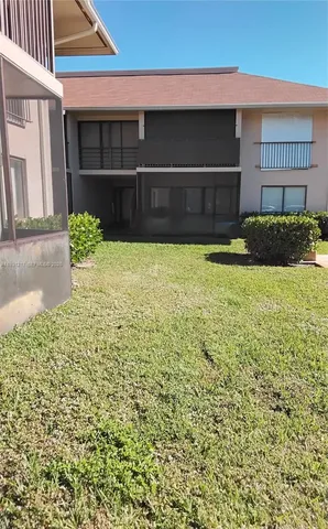 a view of a hallway with wooden floor and windows