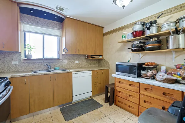 a kitchen with granite countertop a sink and cabinets
