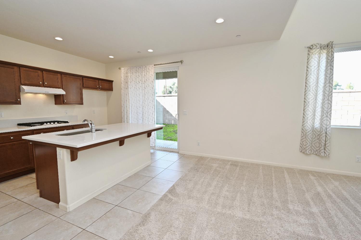 891 North Terra Cotta Drive Fresno, CA 93727 - Photo 15 of 32 a kitchen with stainless steel appliances a sink stove and cabinets