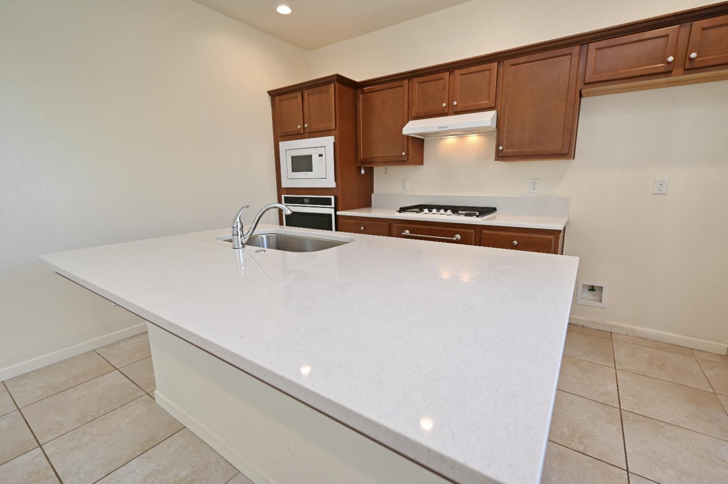 891 North Terra Cotta Drive Fresno, CA 93727 - Photo 5 of 32 a kitchen with a stove and a refrigerator