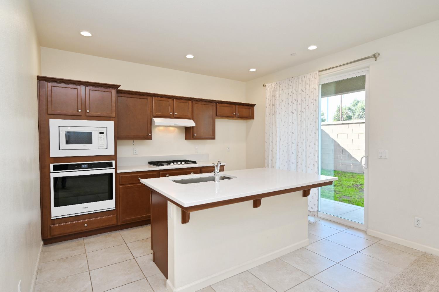 891 North Terra Cotta Drive Fresno, CA 93727 - Photo 6 of 32 a kitchen that has a sink and a stove
