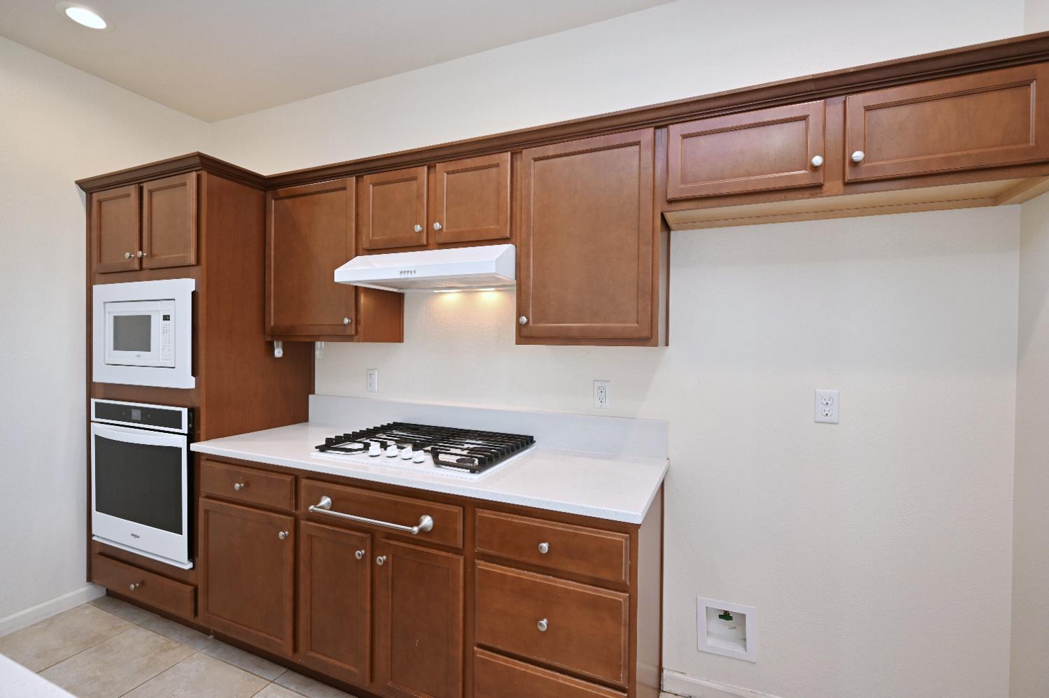 891 North Terra Cotta Drive Fresno, CA 93727 - Photo 8 of 32 a kitchen with cabinets and steel appliances