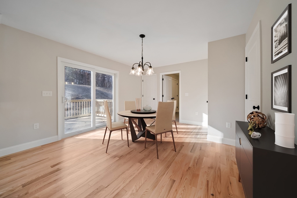 53 Kimball Hill Road, Unit A Hudson, NH 03051 - Photo 11 of 41 a view of a dining room with furniture and wooden floor