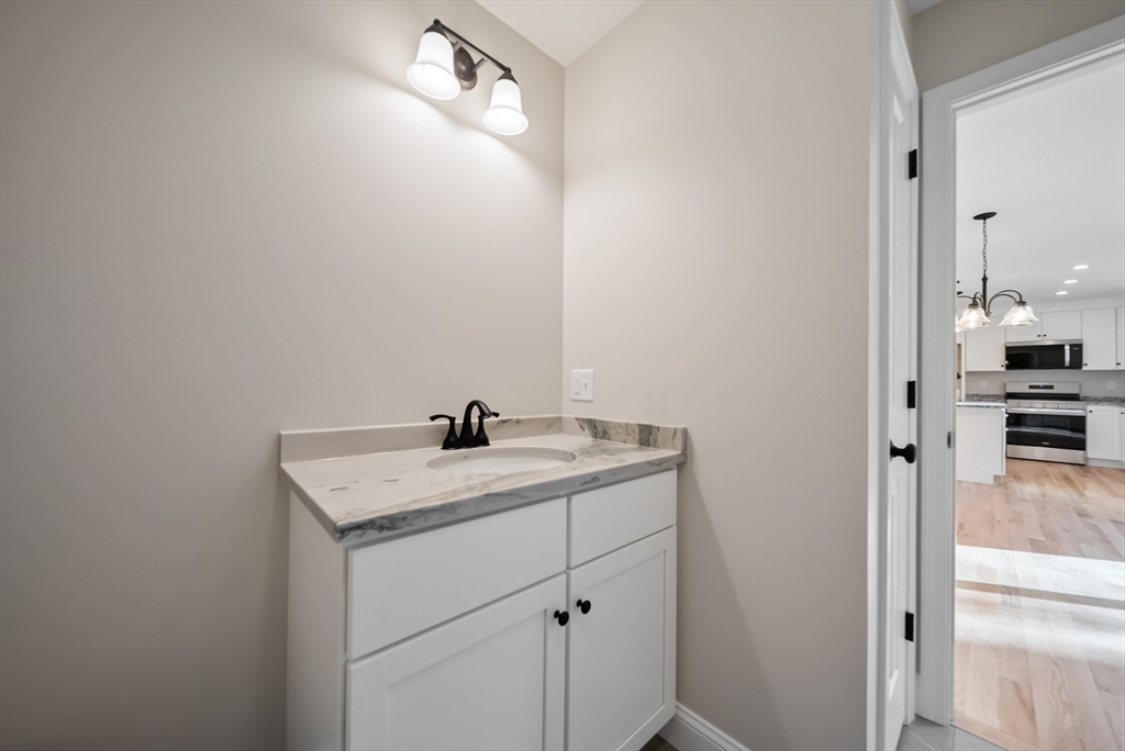 53 Kimball Hill Road, Unit A Hudson, NH 03051 - Photo 13 of 41 a bathroom with a sink a vanity and a mirror