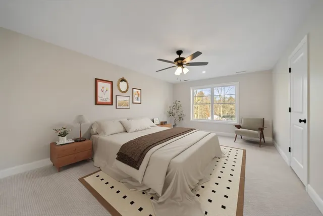 a spacious bedroom with a bed a couch and a window