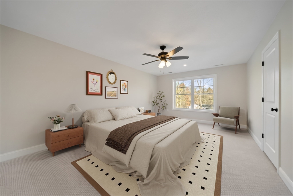 53 Kimball Hill Road, Unit A Hudson, NH 03051 - Photo 18 of 41 a spacious bedroom with a bed a couch and a window